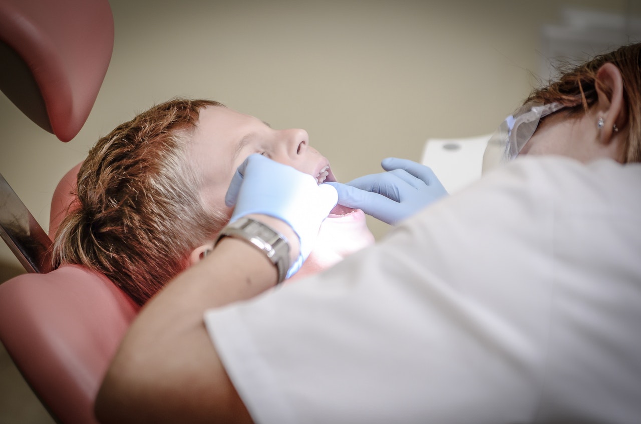 Dentist checking child's teeth
