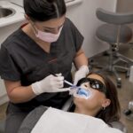 Practitioner applying whitening gel in clinic