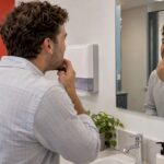 Man checking his smile after whitening